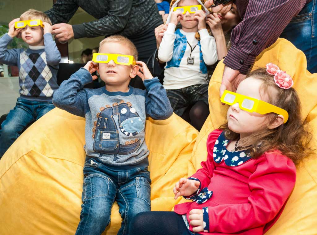 4 kids in yellow 3D glasses